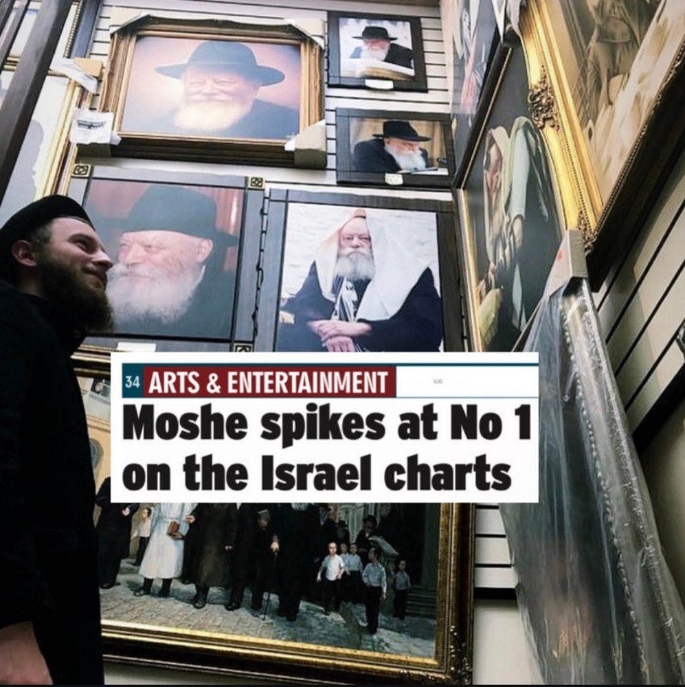 Moshe Reuven beside portraits of the Lubavitcher Rebbe, with the headline: Moshe spikes at No 1 on the Israel charts